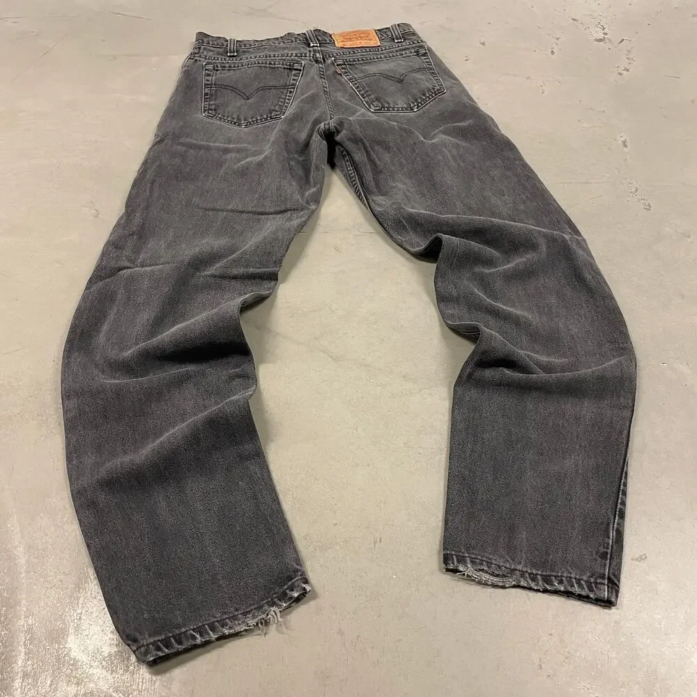 90s faded black Levi’s 550 paper tab jeans 32x33